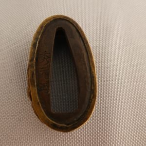 Japanese Sword Kashira featuring a dragon in gold, "signed".