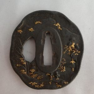 Japanese Edo period tsuba (sword guard) for wakizashi (short sword). Two people and "matsu" pine trees in gold and copper inlay.