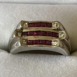 Heavy platinum art deco ring embedded with rubies and diamonds. 16.3 grams total weight.