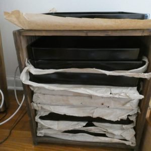 Set of ten black laquered trays in original wooden case.